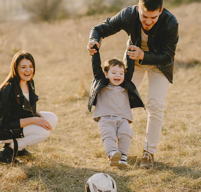 Family playing soccer