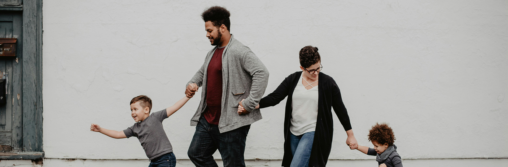 Family walking on sidewalk